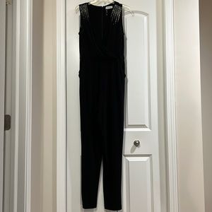 Black v- neck Calvin Klein jumpsuit with rhinestones.